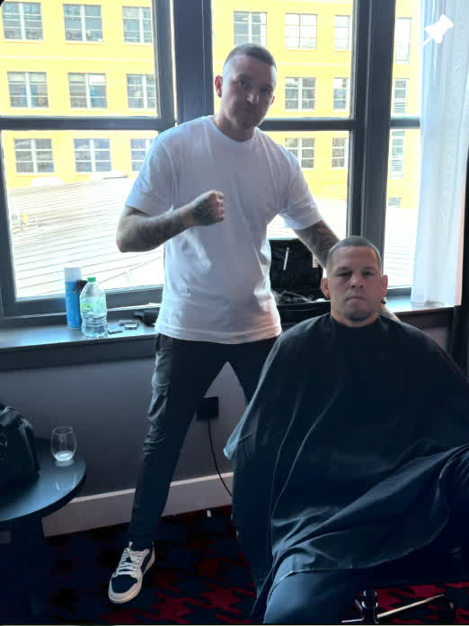 Sean beside a client in the barber chair